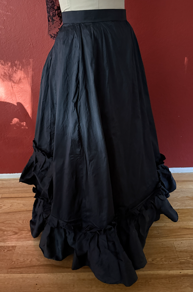 1870s Reproduction Black Watteau Silk Underskirt Right Quarter View. 
