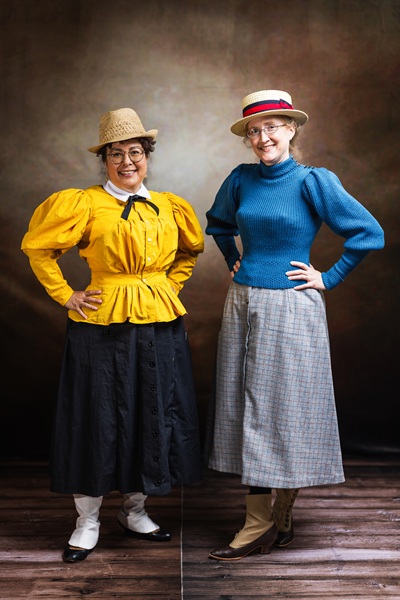 Reproduction 1890s Yellow Cycling on left and friend at Costume College 2025. Photo by Mark Edwards Photographer. Truly Victorian TV494 Shirtwaist. Truly Victorian TV299 Split Skirt. Laughing Moon B7 Gaiters. 
